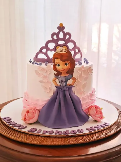 A Princess Sofia the First cake, featuring a 3D fondant skirt for the princess and a beautiful purple crown topper.