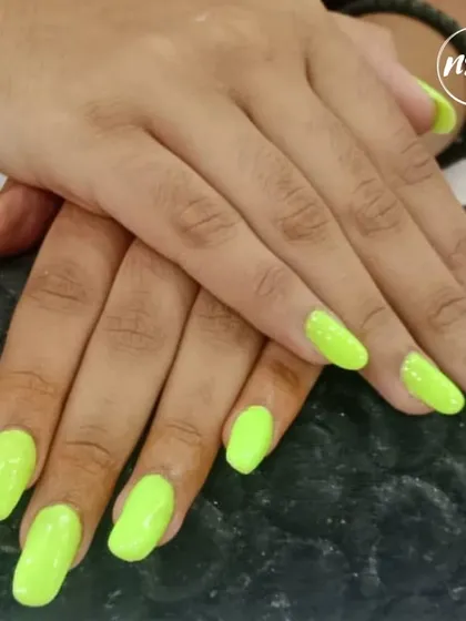 A bright and bold neon yellow set, perfectly shaped and applied by a student. This shows their confidence in working with vibrant colors.
