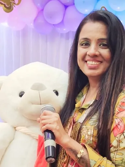 Posing with my little friend, the teddy bear, at a naming ceremony. The decor details are so important for creating a whimsical and celebratory atmosphere.