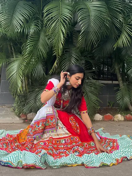 Another lovely shot of this red and white outfit, showing the intricate details of the embroidery and the flow of the skirt.