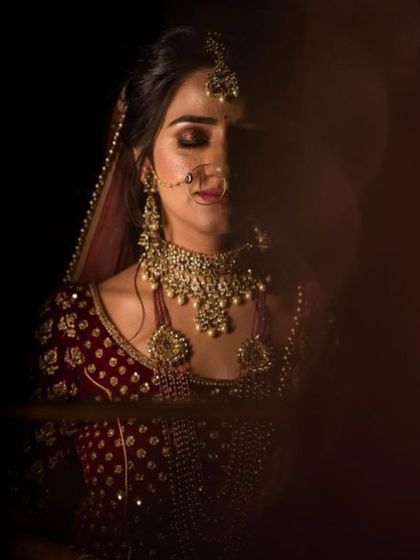 A moody and artistic shot of my bride. The play of light and shadow highlights the details of her makeup and jewelry.