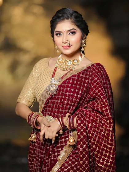 A portrait of our Maharashtrian bride, showcasing the intricate details of her nath and the soft, radiant makeup that enhances her features.