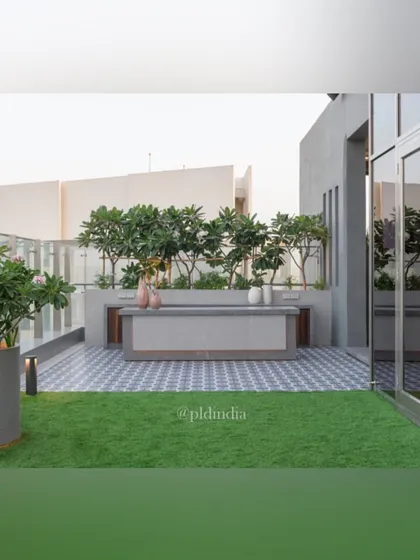 A clean, modern bar and serving counter on the terrace is backed by a screen of trees. This provides privacy and a beautiful natural backdrop for outdoor entertaining.