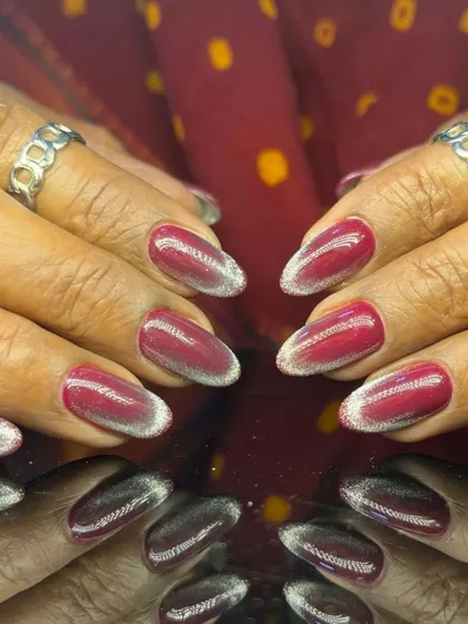 A dramatic red and silver glitter ombre, with a deep crimson fading into a sparkling silver tip.
