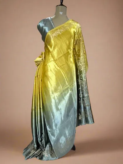 A unique shaded satin crepe saree with a flamingo border, blending from yellow to grey.