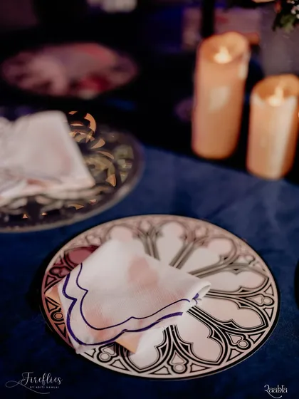 A custom-designed dinner plate featuring Gothic arch motifs, perfectly matching the theme of the 'Palace Ball' Sangeet. Even the tableware was part of the story.