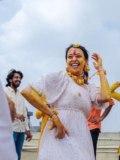 A candid shot of a guest dancing and enjoying the Haldi festivities. We believe in capturing the joy of everyone celebrating your special day.