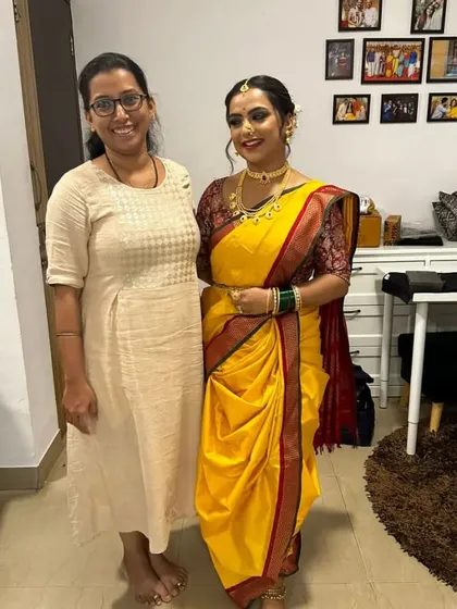 Here I am with a happy client after draping her in a classic yellow Nauvari for Ganesh Chaturthi. It's always a joy to help women connect with their roots through this beautiful attire.