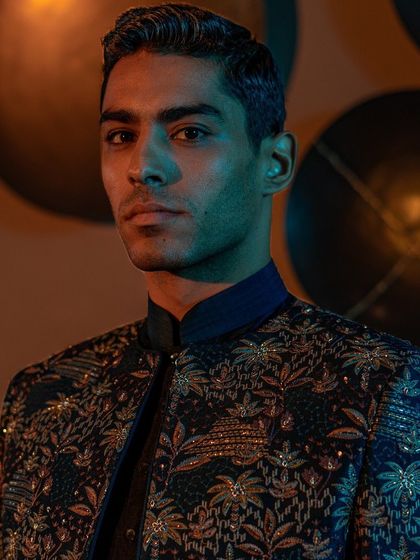 A close-up portrait highlighting the exquisite embroidery on a contemporary jacket from our Raaya collection. The detail showcases the harmonious blend of traditional craftsmanship and modern design.