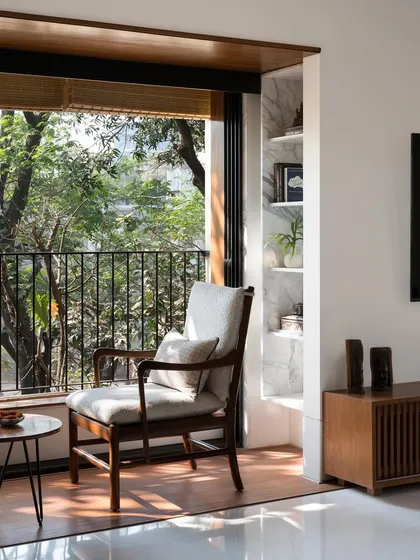 We create intimate moments within a home, like this quiet seating area for two. By perfectly framing the lush greenery outside, we turn a simple window into a private retreat, blending the interior with nature.