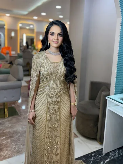 A full-length view of her stunning golden gown.