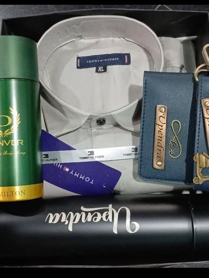 A premium hamper featuring a Tommy Hilfiger shirt, a personalized wallet and keychain, and a custom name flask.