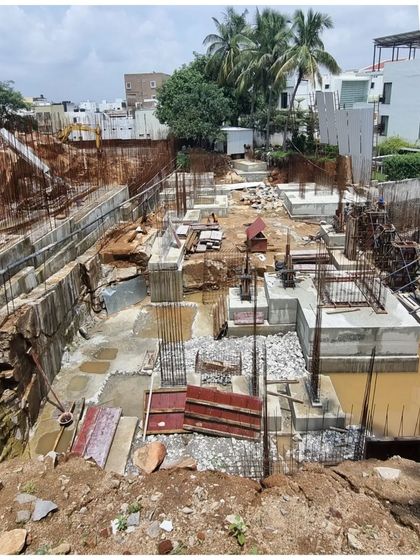 The foundations for Office A being laid in a deep excavation site in Hyderabad. This image shows the very beginning of a complex architectural journey.