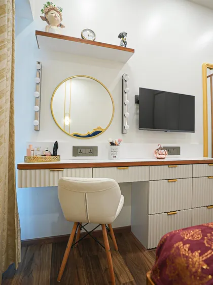 A close-up of the vanity chair and dresser details, highlighting the mix of textures and finishes that give the room its unique character.