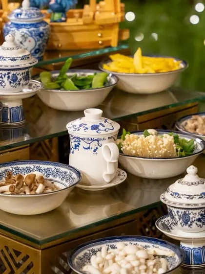 A beautiful display of fresh ingredients for our live Teppanyaki station. Guests can choose from a variety of mushrooms, vegetables, and proteins, all served in elegant blue and white porcelain.
