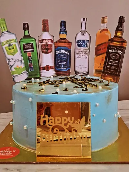 A fun and popular cake for a husband's birthday or a bachelor party. This cake is customized with edible toppers of various miniature liquor bottles like Jack Daniel's, Smirnoff, and Absolut Vodka.