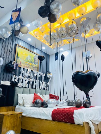 A close-up of the personalized photo decorations hanging from the ceiling balloons, a popular add-on for my birthday packages.