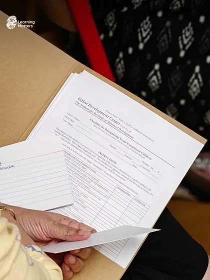 A participant holds a checklist for recognizing traits of giftedness in young children. Our workshops provide research-based tools and formal assessment guides to help educators and parents identify and support different learning needs accurately.