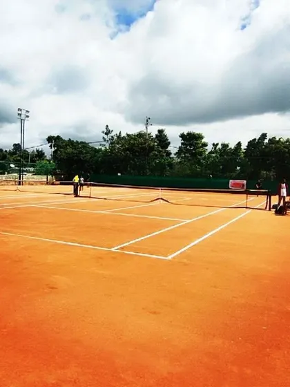 A wide view of my professionally maintained clay courts at the Tennis360 academy, prepared for a day of competitive AITA tournament matches.
