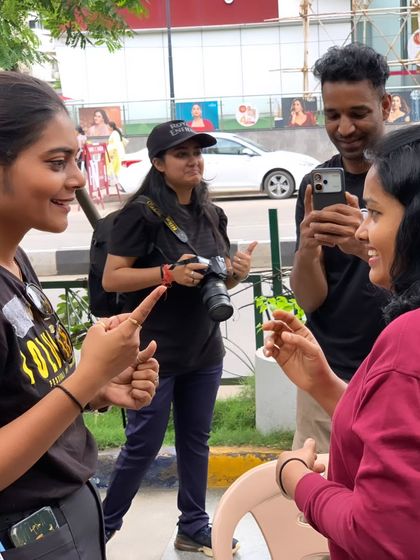 Learning in action. Volunteers and participants engage in a conversation using sign language outside during Sign Fest. We take learning beyond the classroom and into real world interactions.
