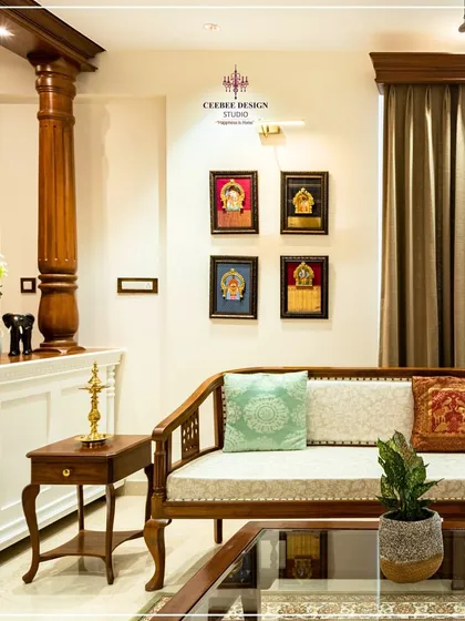 I believe a home should be a canvas for our cultural legacy. This living room is inspired by the timeless elegance of Kerala's architecture, featuring a traditional carved wooden sofa, a stately pillar, and a curated gallery of Tanjore paintings. It’s a space that feels both luxurious and deeply rooted in Indian heritage.