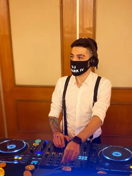DJing a Gatsby-themed wedding party, complete with a custom mask and suspenders to match the event's style. I enjoy collaborating on themed events and tailoring my look to enhance the overall experience for guests.