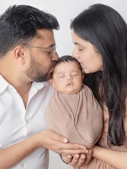 Gentle kisses for their new baby. This is a classic newborn photography pose that is always full of emotion.