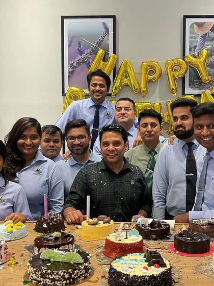 Celebrating a team member's birthday at the office. We are more than just colleagues; we are a real estate family committed to supporting each other and our clients.