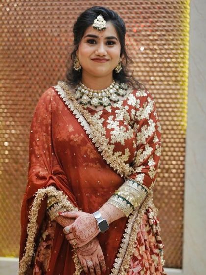A portrait against a textured background, highlighting her beautiful outfit and makeup.