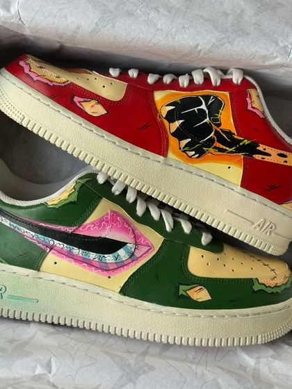 The Luffy and Zoro custom sneakers held up, showing the intricate details of the hand-painted anime art.