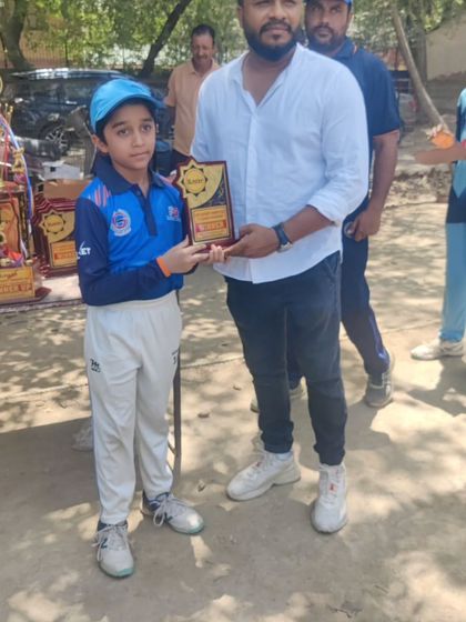 Another one of my young champions receiving his winner's plaque. I make sure every player's effort is recognized.