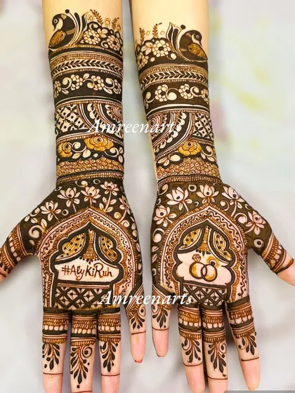 Your wedding hashtag becomes a permanent memory. This engagement design features the hashtag #AlyKiRuh and interlocking rings, framed by intricate patterns.