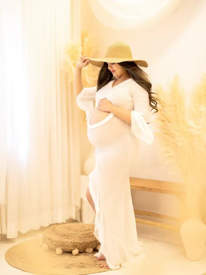 Adding a simple prop like a sun hat can completely change the vibe of a portrait, giving it a chic, summery feel.
