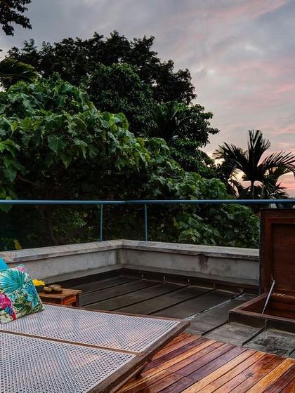 The private terrace of the Tower Room at sunset. This elevated deck offers panoramic views of the surrounding landscape and is an ideal spot for stargazing.