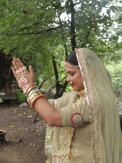 The side profile of a Rajasthani bride, showing the delicate 'nath' and the graceful drape of the 'odhni'.