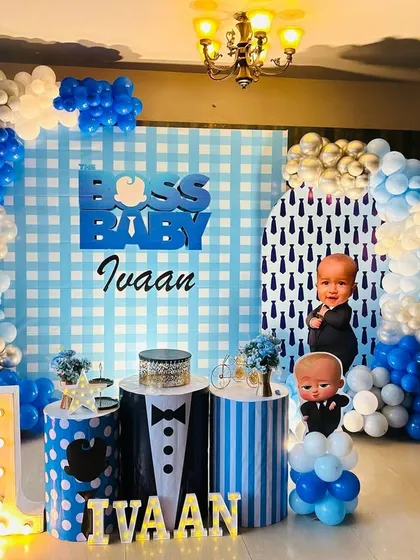 Another Boss Baby setup, this one featuring a checkered backdrop and tuxedo-themed cake stands for a stylish party.