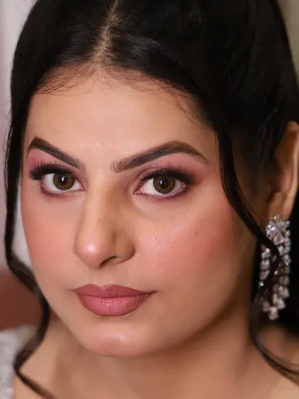 A close-up of this HD engagement look. The eye makeup is a soft pink with a defined crease, paired with a matte mauve-pink lipstick for a modern, romantic feel.