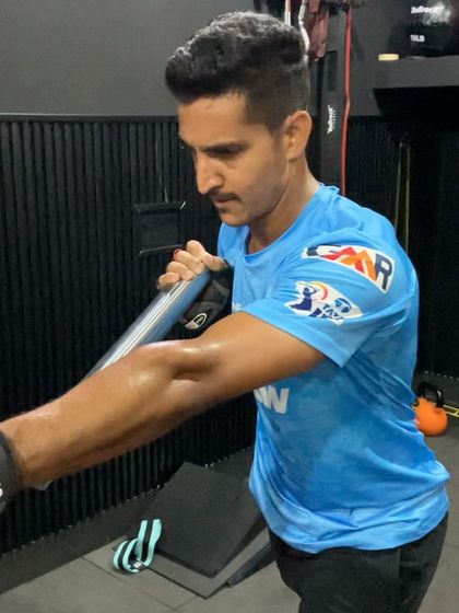 A close-up of a landmine rotational press, highlighting the engagement of the core and shoulder muscles.