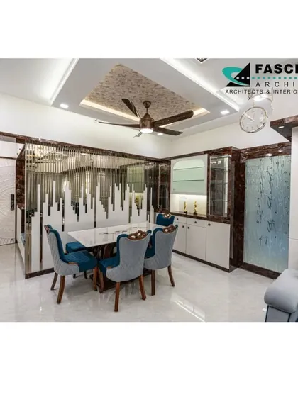 This dining space at Lodha Belair features a striking decorative partition made of polished metal and glass, separating the area while maintaining an open feel. The design showcases our use of custom elements to define spaces elegantly.