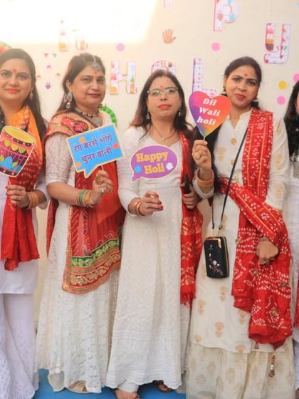 Our students posing with fun props during our Holi event. We create a welcoming and festive atmosphere where everyone feels like part of the family.