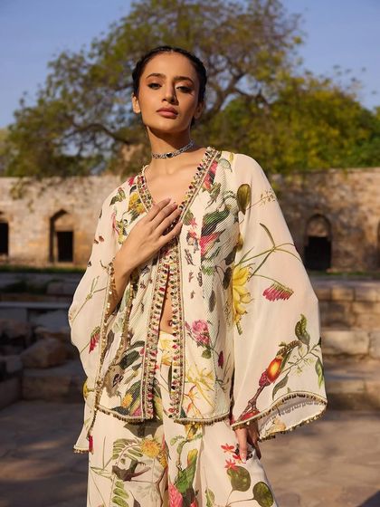 A close-up of the off-white floral co-ord set, highlighting the delicate beaded border on the jacket.