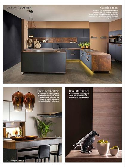 This kitchen design, featured in a design dossier, showcases calm harmony. The dark cabinetry is offset by warm metallic accents and a textured backsplash, creating a space that is both moody and inviting, with real-life touches that make it feel like a home.