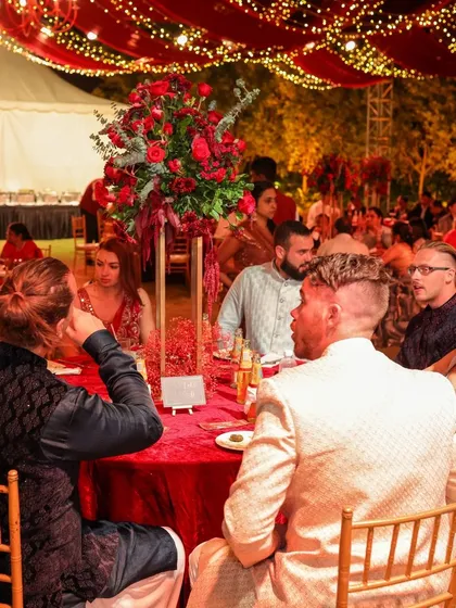 We believe a reception should feel like a galaxy of joy. For this night, we draped the sky in rich red fabric and a constellation of fairy lights, creating a warm, vibrant space where guests could share laughter and make memories under the stars.