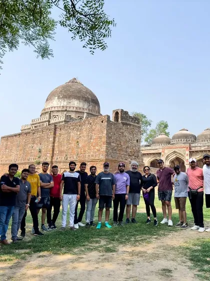 Our group stands before a magnificent tomb in Lodhi Garden. This park is a treasure trove of 15th-century architecture and a key part of our South Delhi tours.
