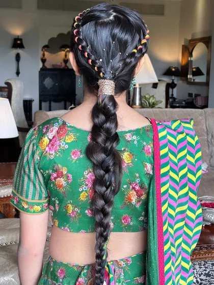 A playful and colorful braid perfect for a Mehendi or Haldi ceremony. I wove multi-colored threads into a classic braid and added a crown braid for extra detail, creating a fun and youthful look.
