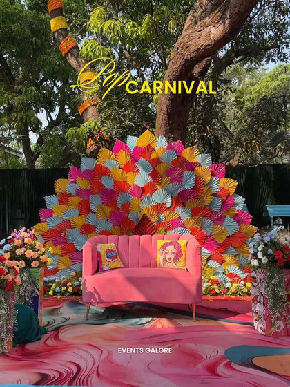 A Haldi ceremony should be an explosion of joy. For Jay and Jinal's 'Pop Carnival' theme, I used a riot of color, quirky pop-art cushions, and a dramatic fan-style backdrop to create a fun, high-energy photo spot that perfectly captured their vibrant personalities.