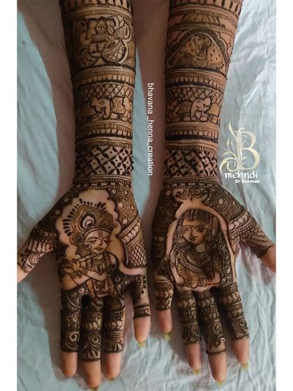 A divine love story for a bridal design. This piece features beautiful portraits of Radha and Krishna on the palms, surrounded by traditional elephant motifs and detailed patterns.