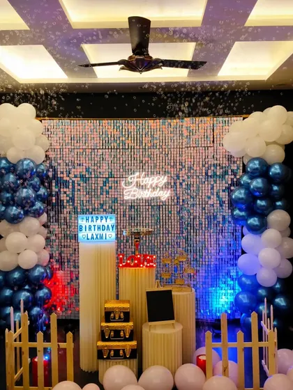 A classic blue and white birthday theme. The setup includes a custom lightbox and decorative pedestals, all ready for your cake and gifts.
