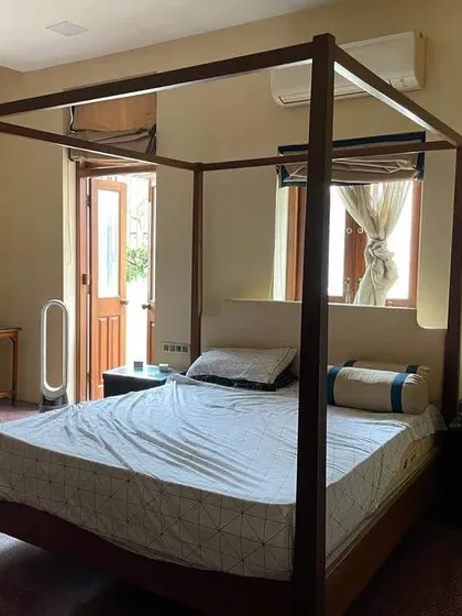 A simple and elegant four-poster bed frame installed in a client's home. This minimalist take on the classic design works well in modern as well as traditional interiors.