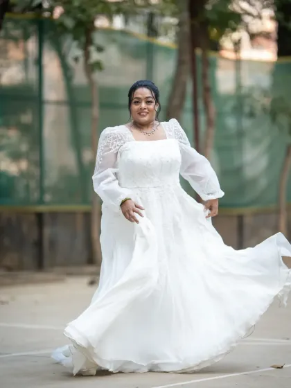 A joyful, twirling bridal portrait. This shot is full of movement and happiness, perfectly capturing the bride's excitement on her wedding day.
